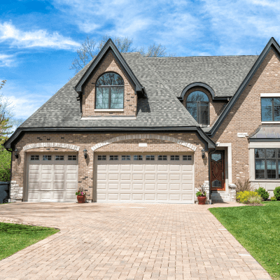 A large brick home in Port Royal, South Carolina, featuring a spacious driveway and attached garage.