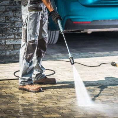  A man pressure washes a car in Okatie, South Carolina, showcasing effective cleaning techniques and equipment.